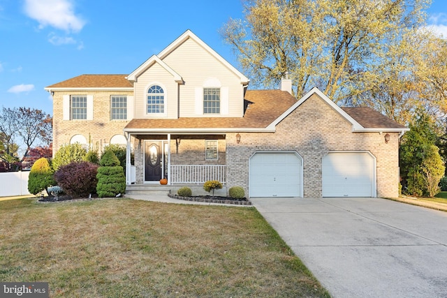 view of front facade with covered porch, a front yard, and a garage