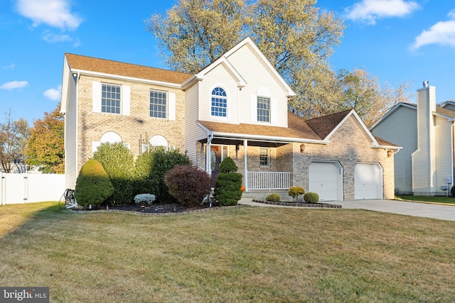 view of front of property featuring a porch, a garage, and a front lawn