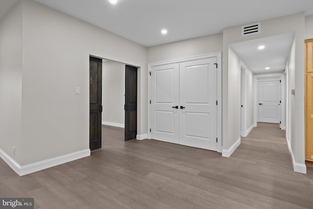 hall with light hardwood / wood-style floors