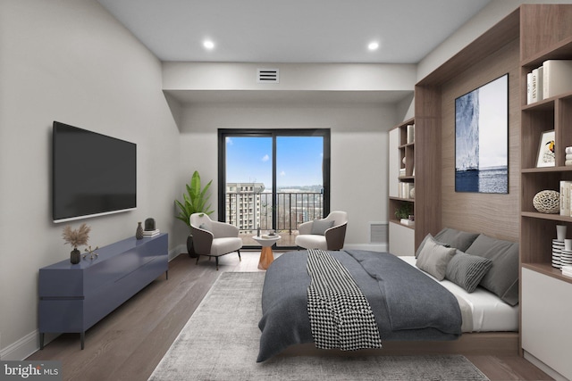 bedroom featuring wood-type flooring and access to exterior