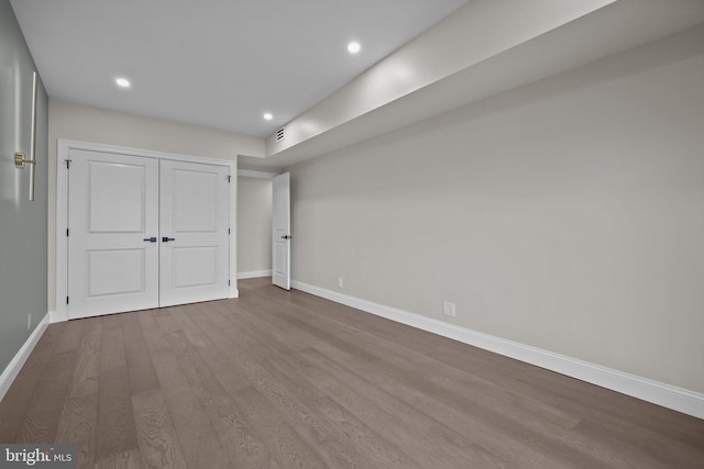 unfurnished bedroom featuring light hardwood / wood-style flooring and a closet