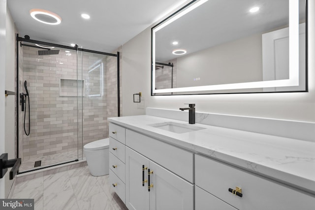 bathroom with an enclosed shower, vanity, and toilet