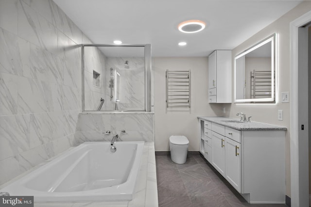 full bathroom featuring toilet, vanity, and separate shower and tub