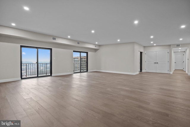 unfurnished living room featuring light hardwood / wood-style flooring