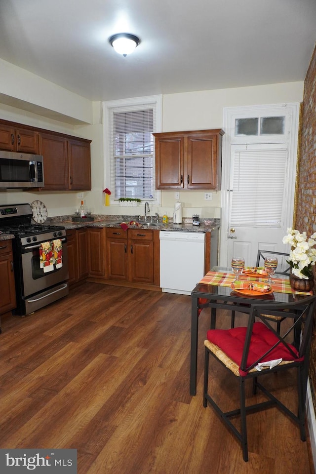 kitchen featuring dark wood-type flooring, appliances with stainless steel finishes, and sink