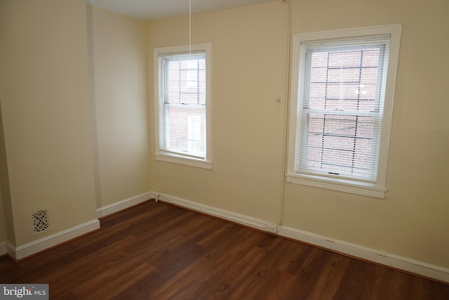 spare room with dark hardwood / wood-style flooring