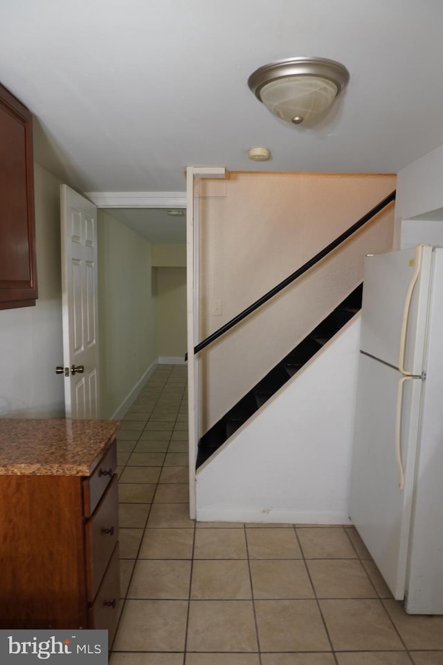 kitchen with white fridge and light tile patterned flooring