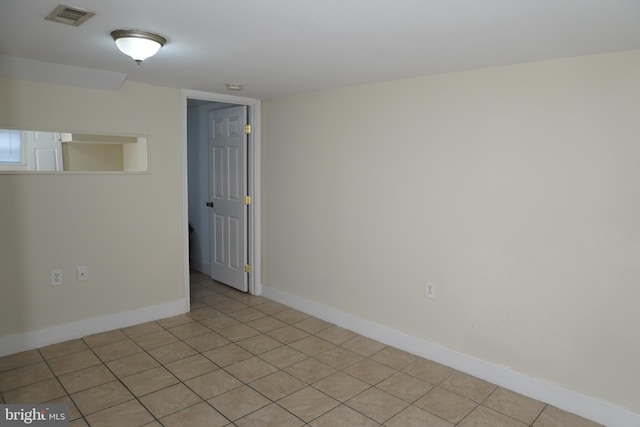 unfurnished room featuring light tile patterned flooring