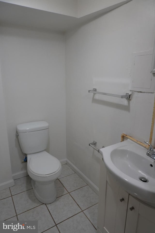 bathroom with vanity, toilet, and tile patterned flooring