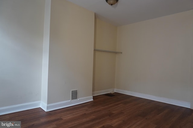 unfurnished room featuring dark hardwood / wood-style flooring