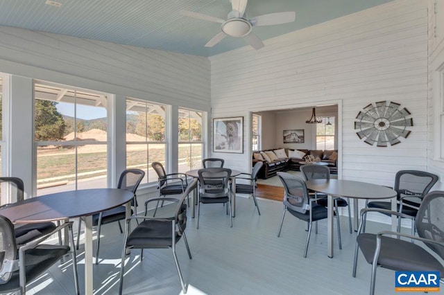 sunroom / solarium with ceiling fan, lofted ceiling, and a healthy amount of sunlight