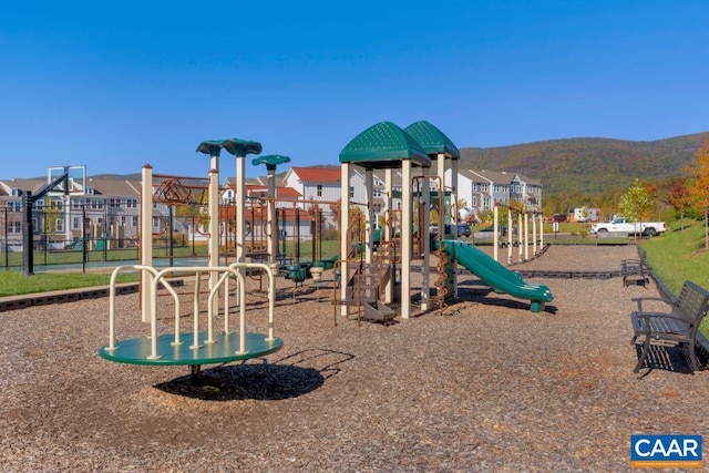 view of jungle gym with a mountain view