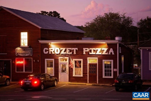 view of outdoor building at dusk