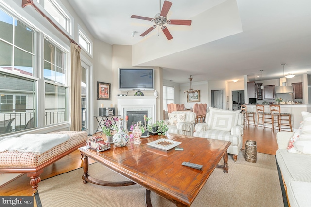 living room featuring light wood-type flooring and ceiling fan