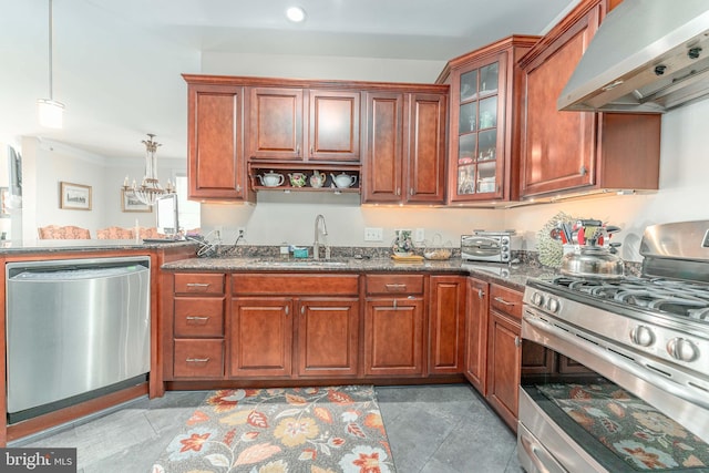 kitchen featuring stainless steel appliances, pendant lighting, sink, extractor fan, and dark stone countertops