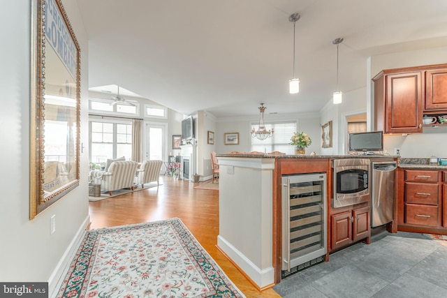 kitchen featuring ceiling fan with notable chandelier, light hardwood / wood-style floors, a healthy amount of sunlight, and beverage cooler