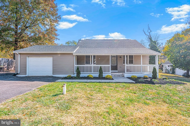 ranch-style home featuring a front lawn, covered porch, and a garage