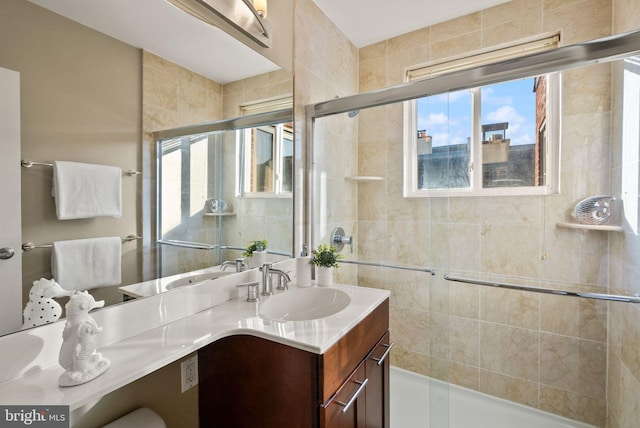 bathroom featuring vanity and a shower with shower door