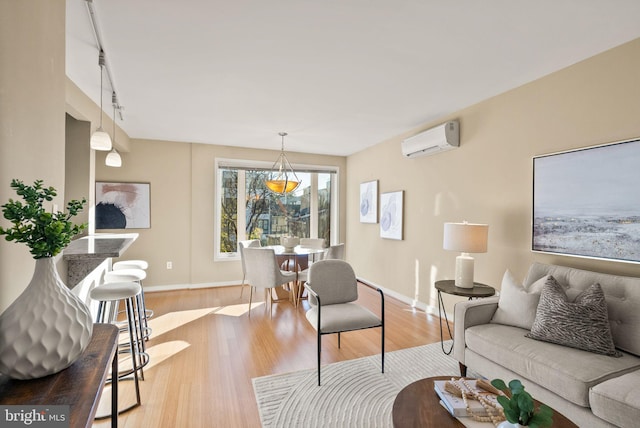 living room featuring light hardwood / wood-style floors and an AC wall unit