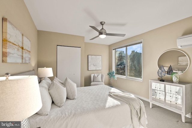 bedroom featuring a closet, ceiling fan, carpet, and a wall mounted air conditioner