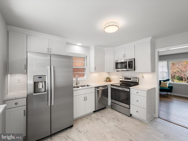 kitchen with white cabinetry, appliances with stainless steel finishes, and sink