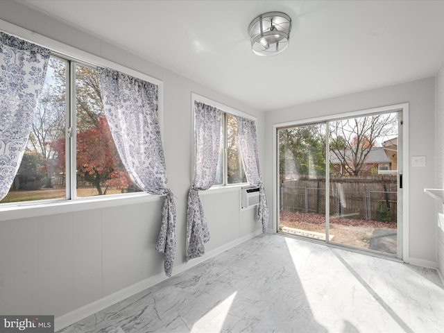 unfurnished sunroom featuring a healthy amount of sunlight and cooling unit