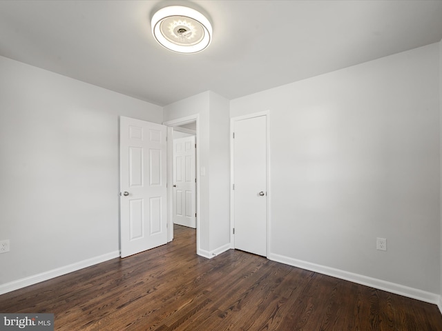 unfurnished bedroom featuring dark wood-type flooring