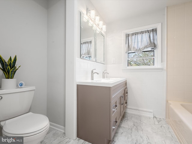 bathroom with toilet, vanity, baseboard heating, and tile walls