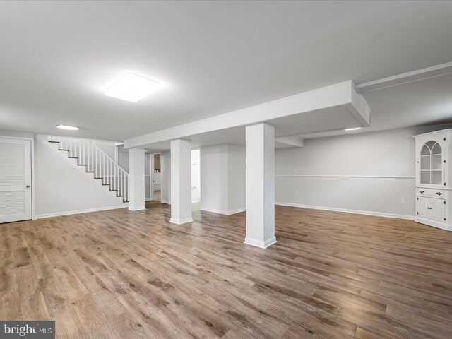 basement with hardwood / wood-style flooring