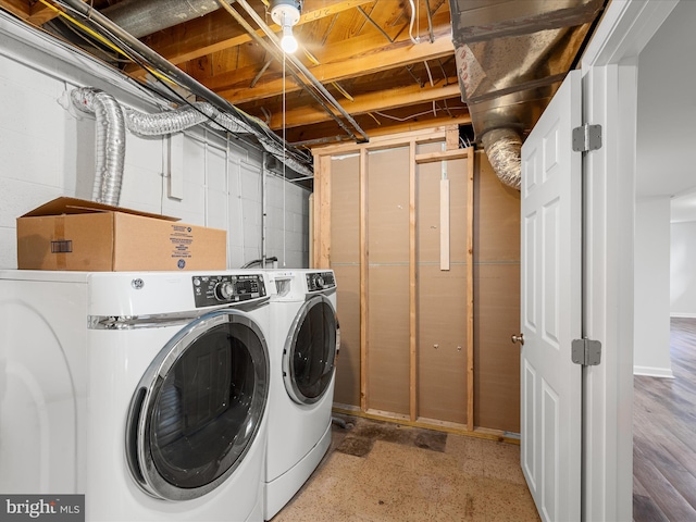 laundry room featuring washer and clothes dryer and hardwood / wood-style flooring