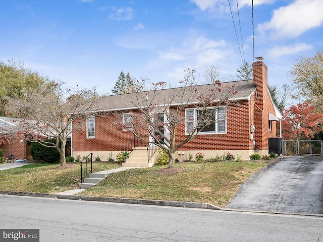 view of front of property featuring a front lawn and central air condition unit