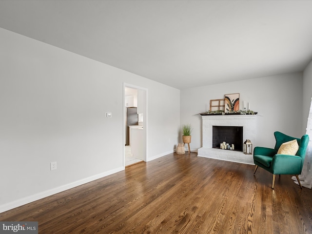 living area with hardwood / wood-style floors and a fireplace