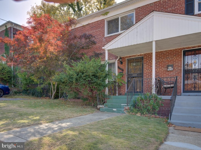 doorway to property with a yard