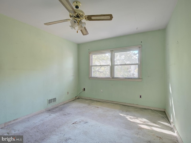 empty room with light colored carpet and ceiling fan