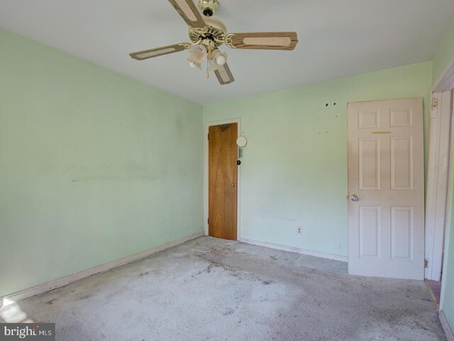 carpeted empty room with ceiling fan