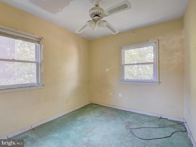 empty room featuring light carpet and ceiling fan