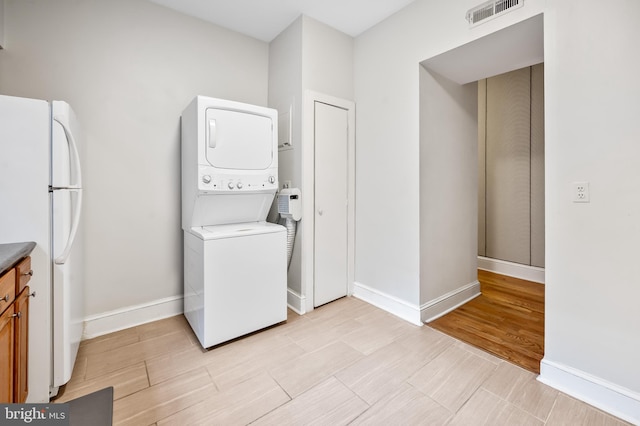 laundry room with stacked washer and dryer