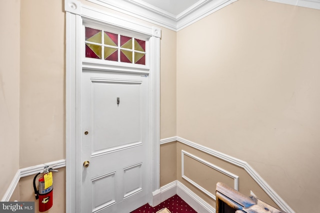 doorway to outside with ornamental molding