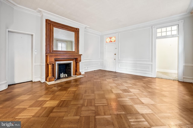 unfurnished living room featuring crown molding, light parquet flooring, and plenty of natural light