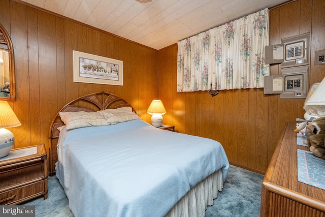 carpeted bedroom featuring wood walls and wooden ceiling