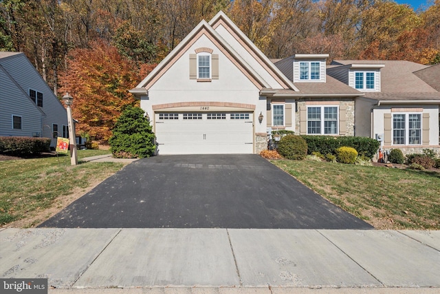 view of property featuring a front yard and a garage