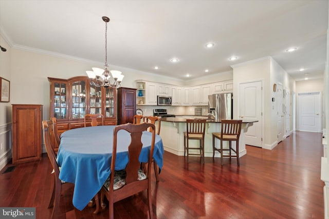 dining area featuring ornamental molding, a chandelier, and dark wood-type flooring