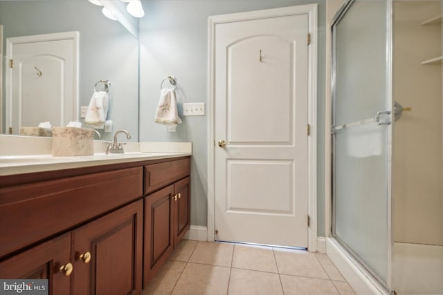 bathroom featuring vanity, an enclosed shower, and tile patterned floors