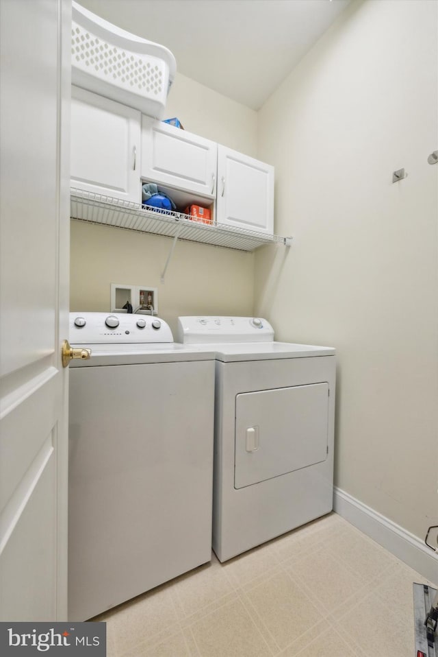 clothes washing area with washing machine and clothes dryer