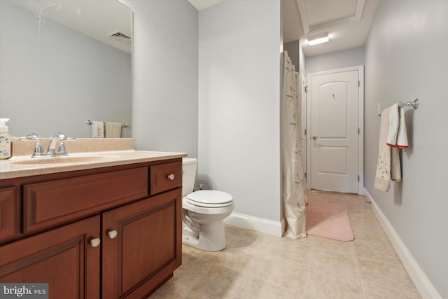 bathroom with toilet, vanity, and tile patterned floors