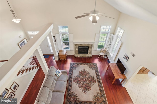 living room with a healthy amount of sunlight, high vaulted ceiling, and hardwood / wood-style flooring