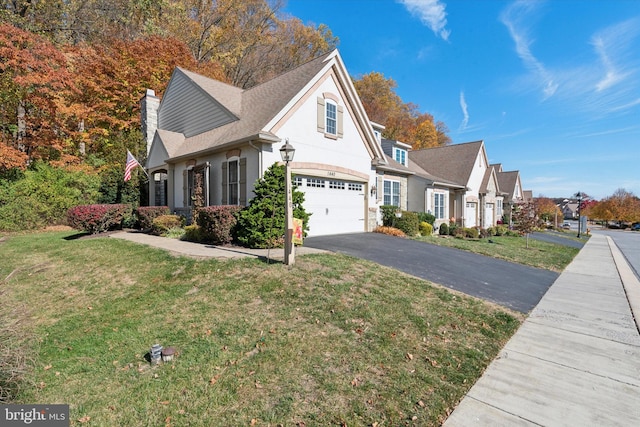 view of property with a front lawn and a garage