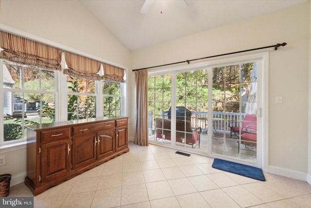 sunroom / solarium featuring ceiling fan, a healthy amount of sunlight, and vaulted ceiling