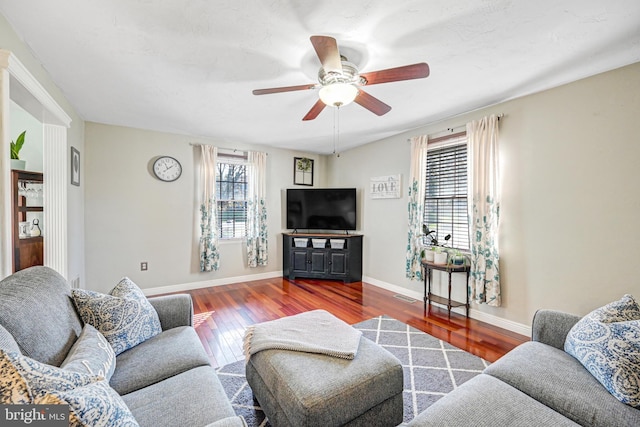 living room featuring ceiling fan and hardwood / wood-style flooring