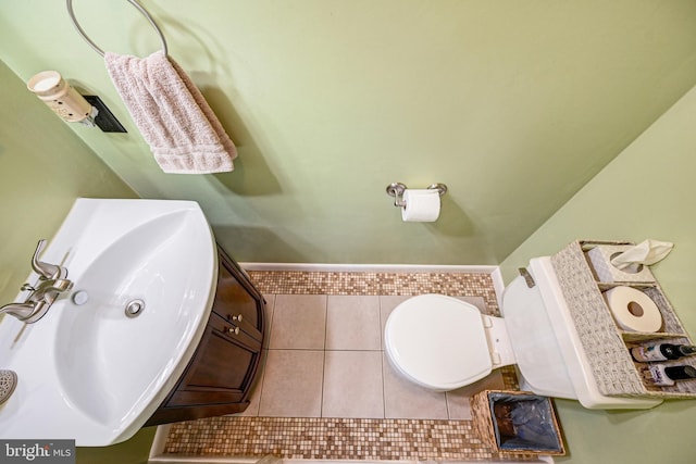 bathroom featuring tile patterned floors, vanity, and toilet